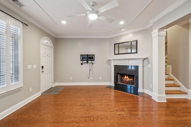 entryway with baseboards, visible vents, stairway, wood finished floors, and a high end fireplace