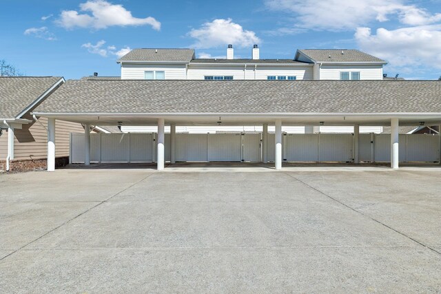 garage with covered parking and fence