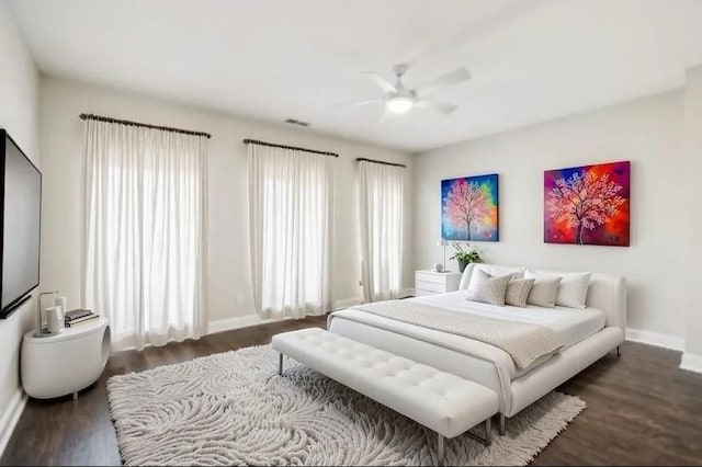 bedroom featuring dark wood-style floors, ceiling fan, and baseboards