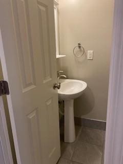 bathroom featuring tile patterned flooring and baseboards