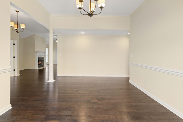 interior space with a chandelier, a lit fireplace, and dark wood finished floors