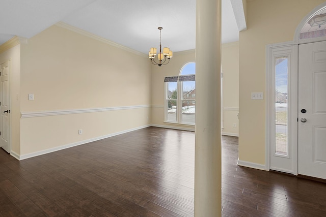 entryway with crown molding, dark wood-style flooring, baseboards, and a notable chandelier