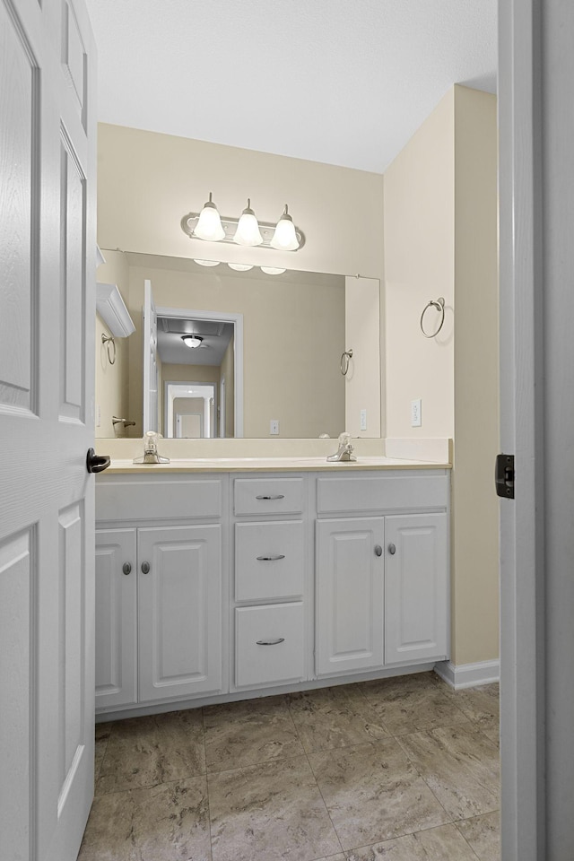 bathroom featuring double vanity and a sink