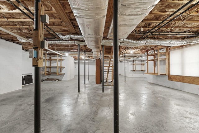 unfinished basement featuring concrete block wall