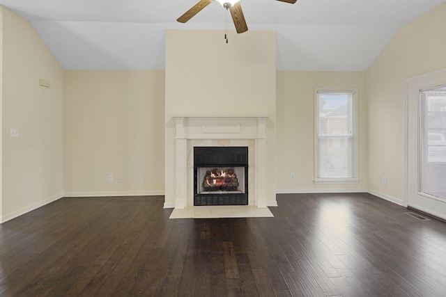 unfurnished living room featuring lofted ceiling, visible vents, wood finished floors, and a high end fireplace