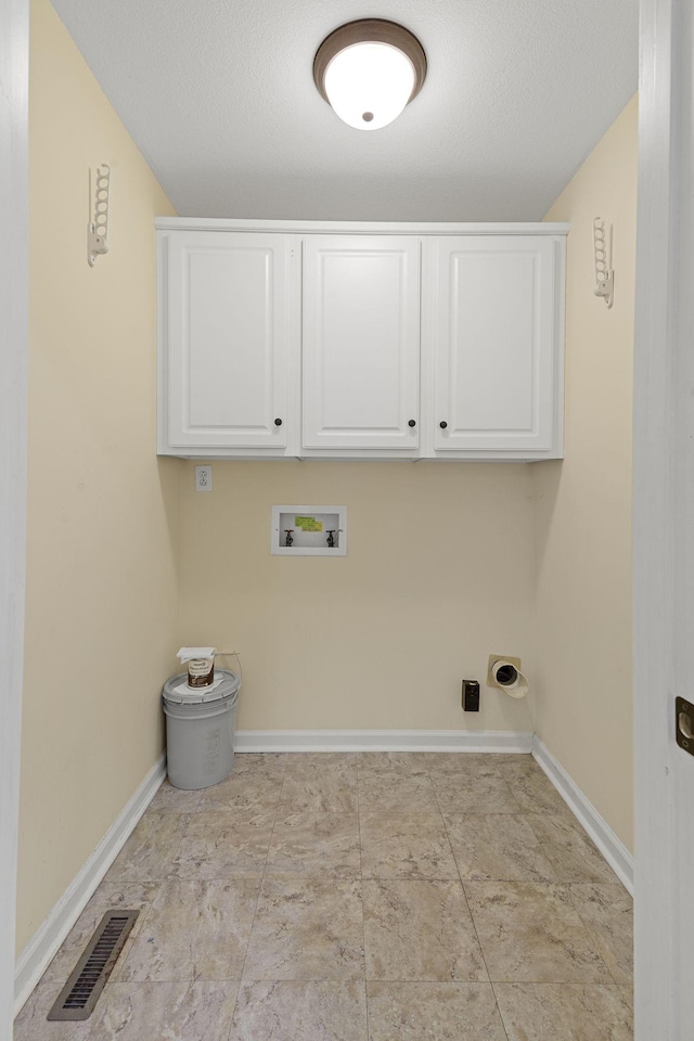 clothes washing area featuring cabinet space, baseboards, visible vents, and washer hookup