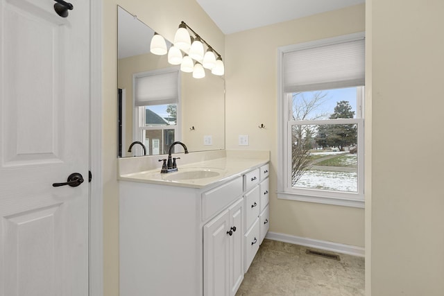 bathroom featuring visible vents, vanity, and baseboards