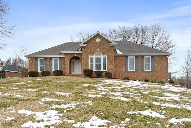 view of front of home with brick siding and a shingled roof