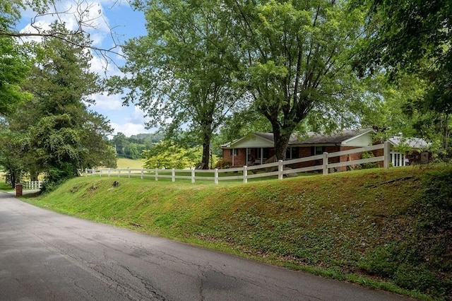 view of yard featuring a rural view and fence