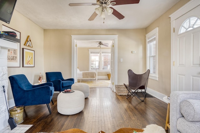 living room featuring dark wood-type flooring and baseboards