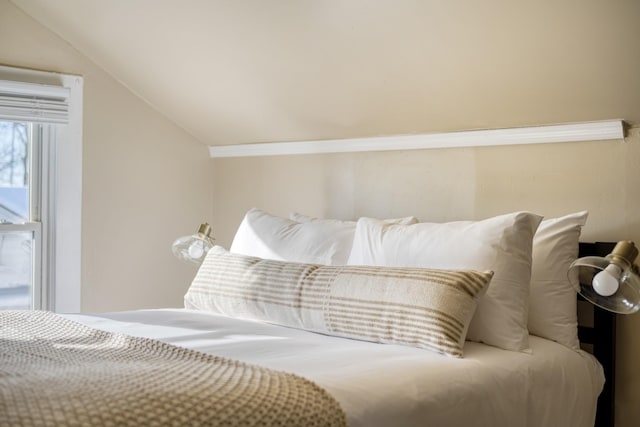 bedroom featuring lofted ceiling