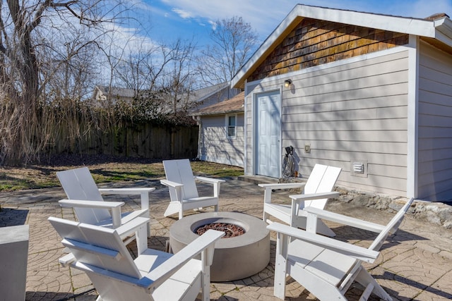 view of patio featuring a fire pit and fence