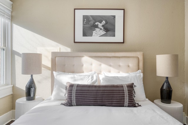 bedroom featuring a textured wall