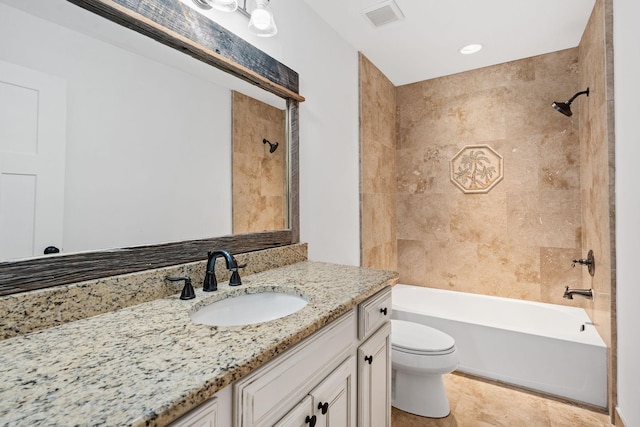 bathroom with tile patterned flooring, toilet, vanity, visible vents, and washtub / shower combination