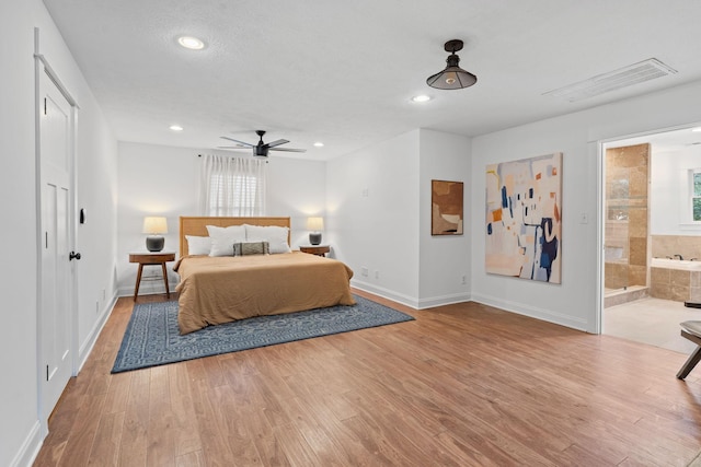 bedroom with light wood-style flooring, recessed lighting, visible vents, and baseboards