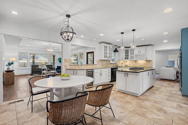 kitchen featuring glass insert cabinets, white cabinets, a kitchen island, and dishwasher