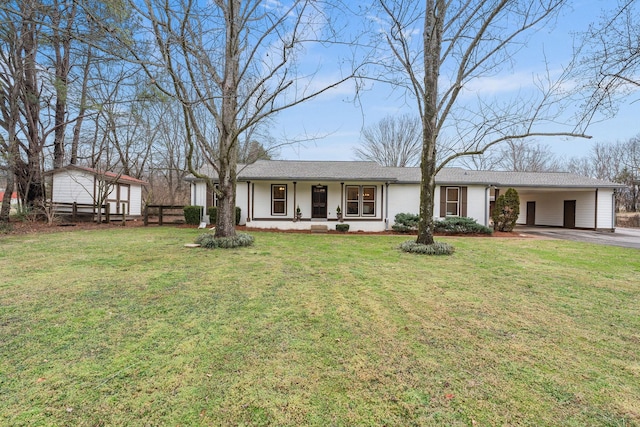 single story home featuring a front yard, covered porch, driveway, and an attached carport