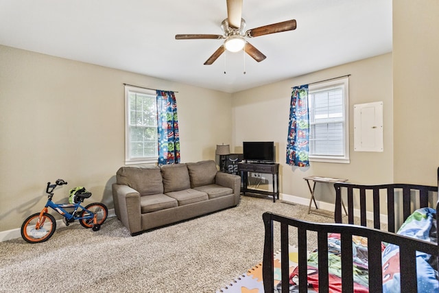 bedroom featuring carpet floors, electric panel, multiple windows, and baseboards