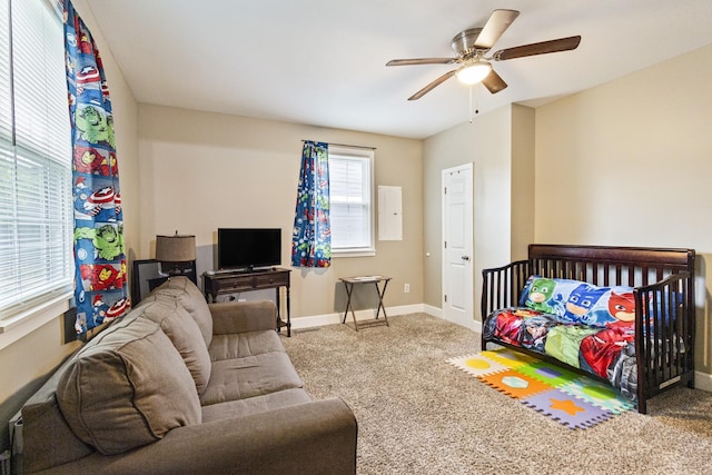 carpeted bedroom featuring ceiling fan and baseboards