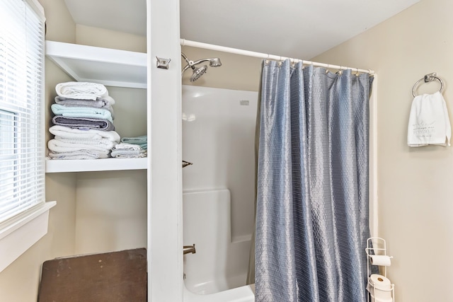 bathroom featuring shower / bath combo and plenty of natural light