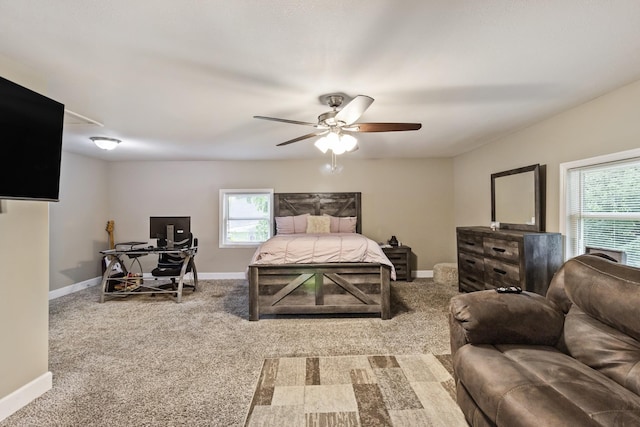 carpeted bedroom with multiple windows, baseboards, and a ceiling fan