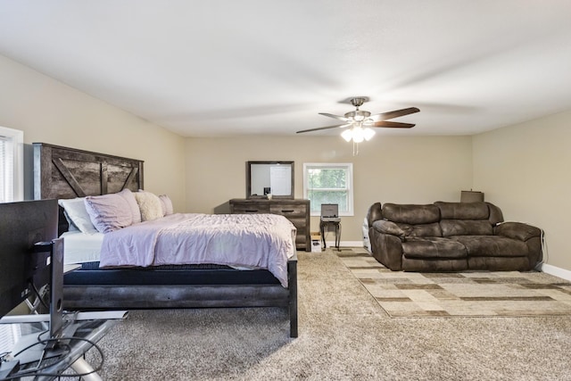 carpeted bedroom featuring ceiling fan and baseboards