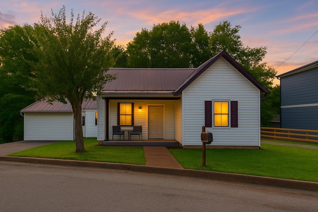 127 Lawn St, Clarksville, TN 37040 - view of front facade featuring covered porch, a lawn, fence, and metal roof