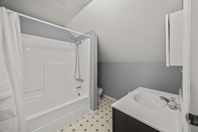 bathroom featuring tile patterned floors, shower / bathtub combination with curtain, vaulted ceiling, a textured ceiling, and vanity