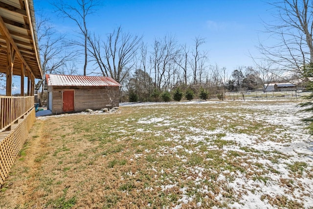 yard covered in snow with an outdoor structure