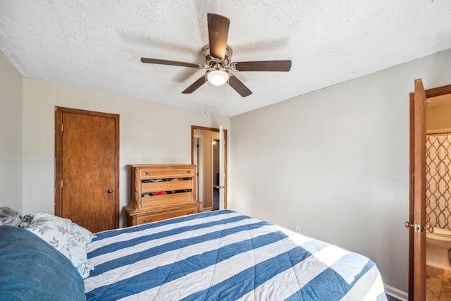 bedroom with ceiling fan and a textured ceiling