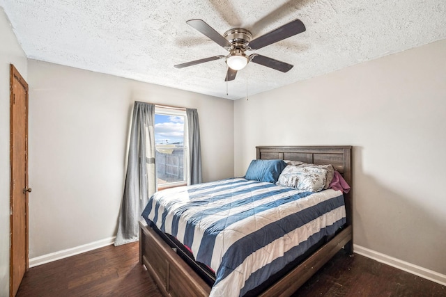 bedroom featuring a textured ceiling, ceiling fan, wood finished floors, and baseboards