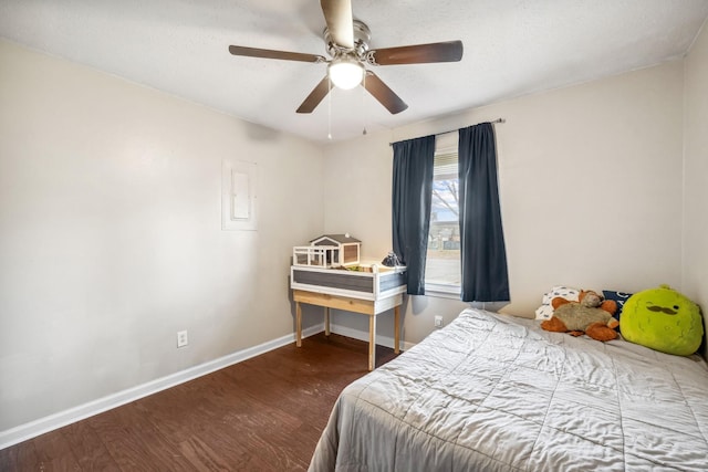 bedroom featuring ceiling fan, wood finished floors, and baseboards