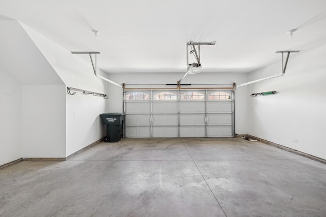 garage with baseboards and a garage door opener