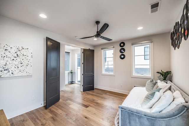 sitting room with baseboards, visible vents, wood finished floors, and recessed lighting