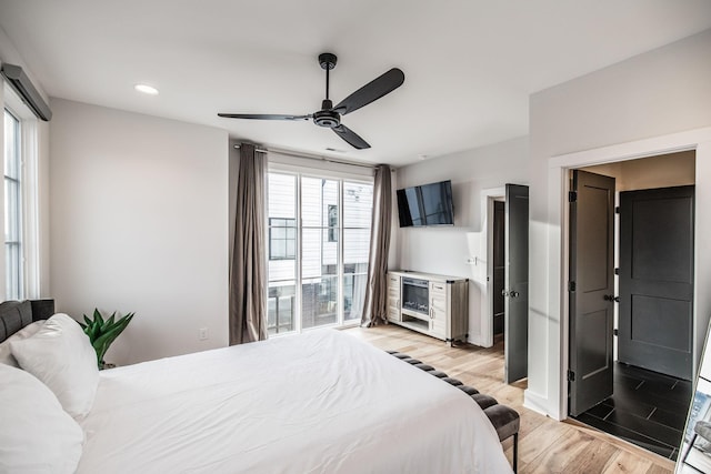 bedroom featuring light wood-type flooring, a ceiling fan, and recessed lighting