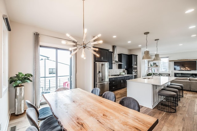 dining room featuring a notable chandelier, recessed lighting, visible vents, and light wood-style floors