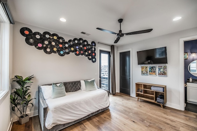 bedroom with light wood finished floors, visible vents, and recessed lighting