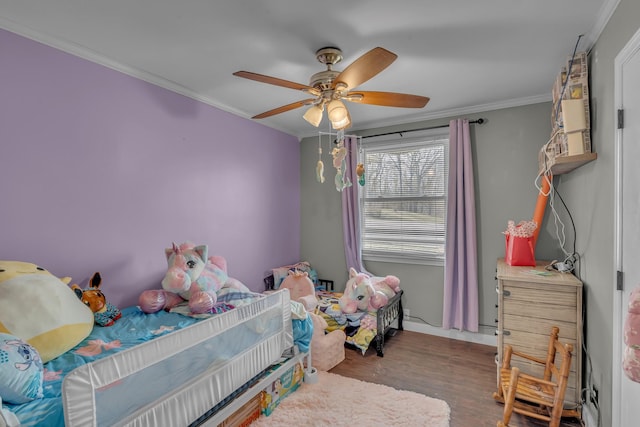 bedroom with a ceiling fan, ornamental molding, and wood finished floors