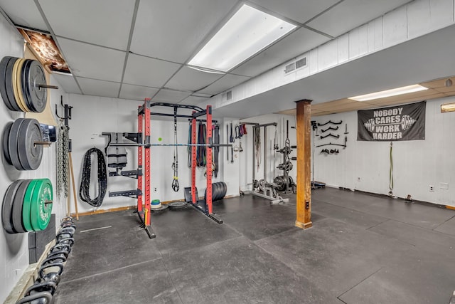 workout room featuring a paneled ceiling and visible vents