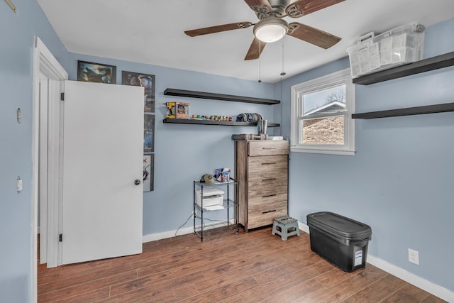 bedroom with ceiling fan, baseboards, and wood finished floors