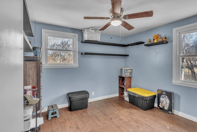 miscellaneous room with ceiling fan, light wood finished floors, and baseboards