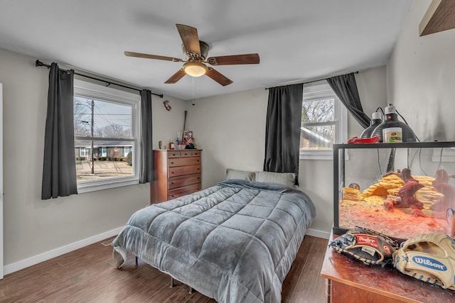 bedroom featuring ceiling fan, baseboards, and dark wood-type flooring