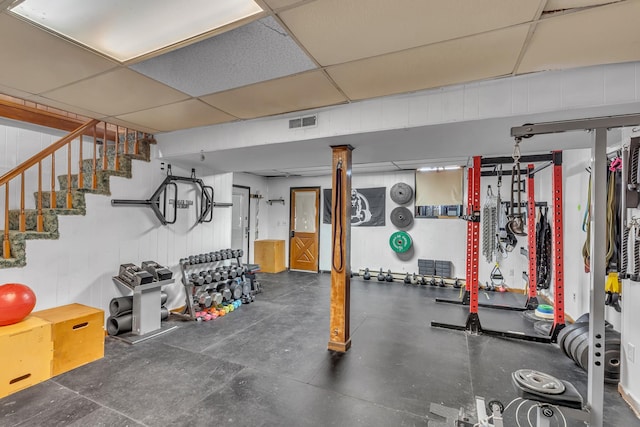 exercise area featuring a paneled ceiling and visible vents