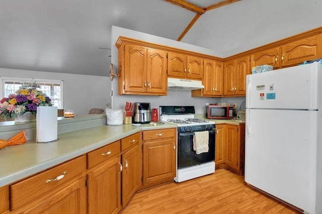 kitchen featuring white appliances, under cabinet range hood, light countertops, and brown cabinetry
