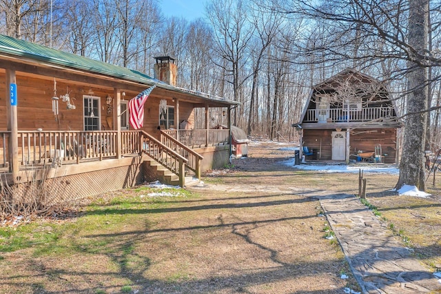 view of yard with covered porch and stairs