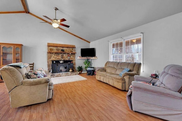 living room with a ceiling fan, high vaulted ceiling, and light wood-style flooring