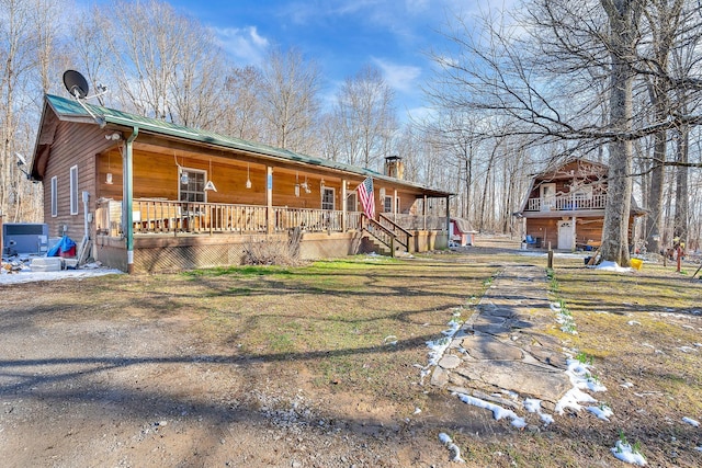 view of home's exterior featuring covered porch, a chimney, and central air condition unit