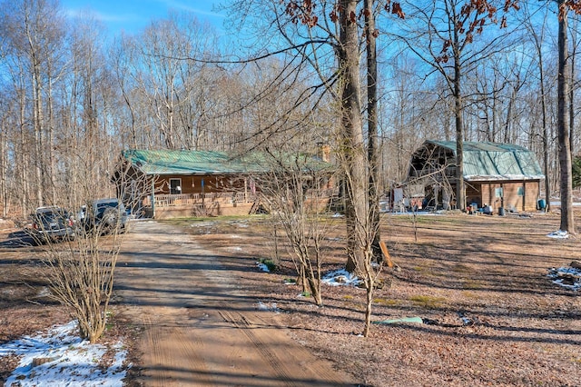 view of front of property featuring metal roof and a barn