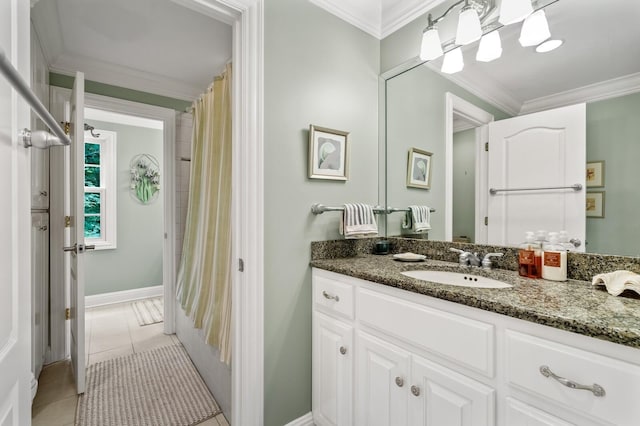 bathroom featuring tile patterned flooring, crown molding, and vanity