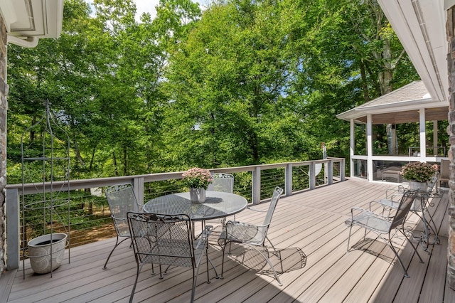 wooden deck featuring outdoor dining area